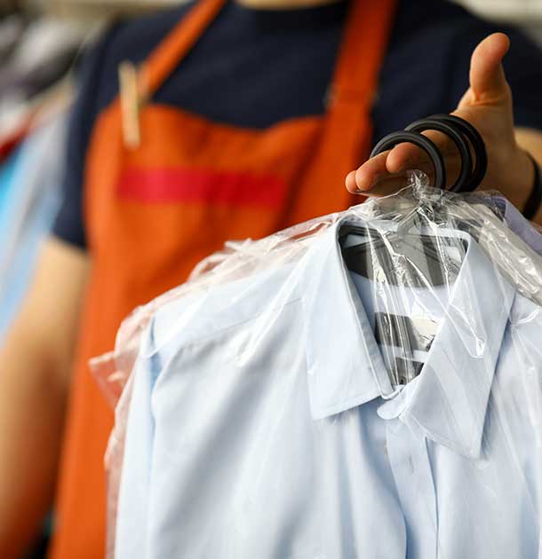 KDC Clothes dry cleaning service worker returning shirts to customer